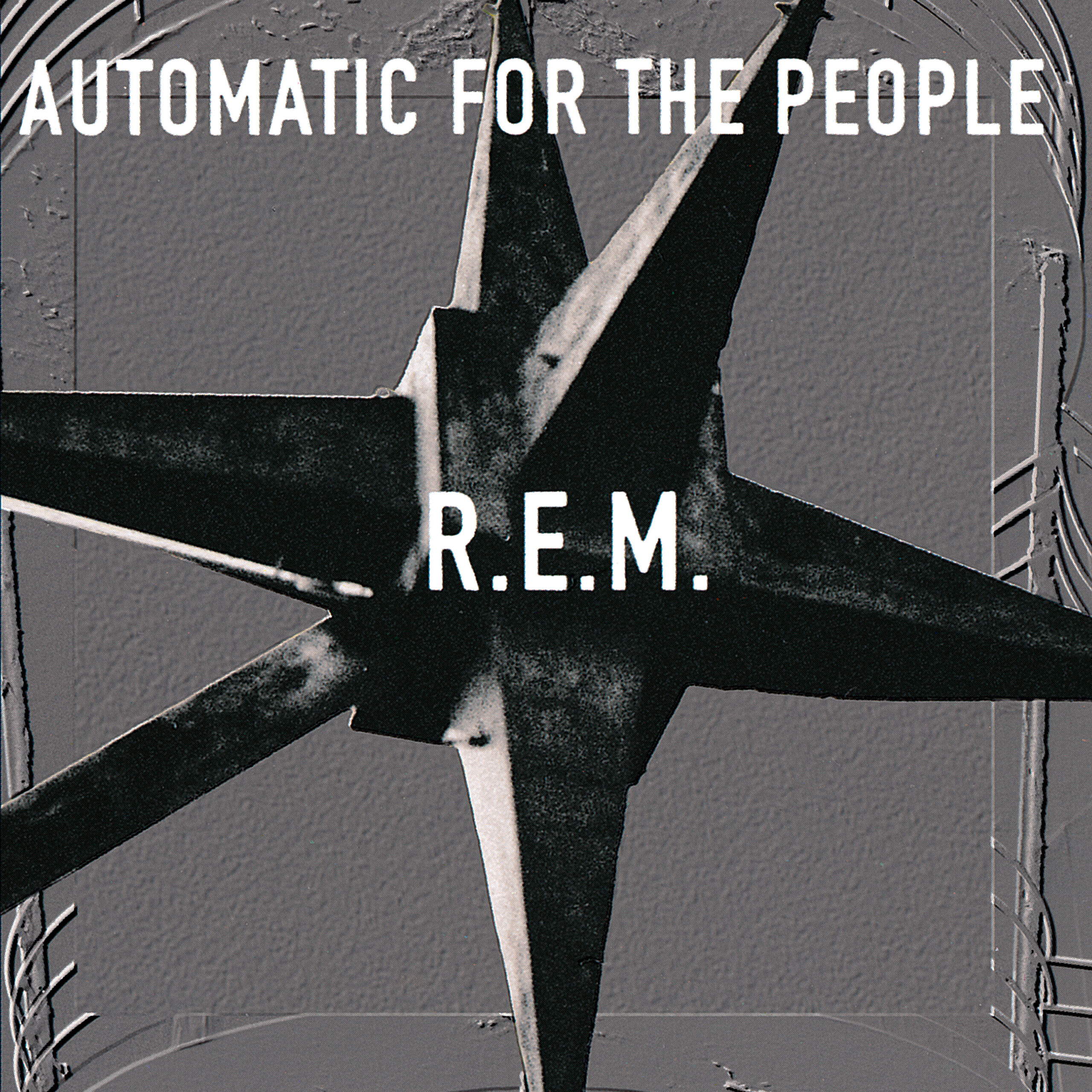 Album cover for Automatic for the People by R.E.M., featuring a black star-shaped sculpture on a grey background with white text at the top and band name in the centre.